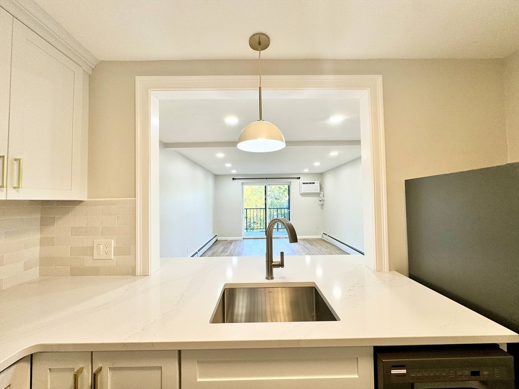 a view of a kitchen with a sink and a chandelier