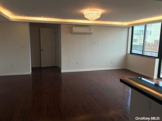 a view of room with window and wooden floor