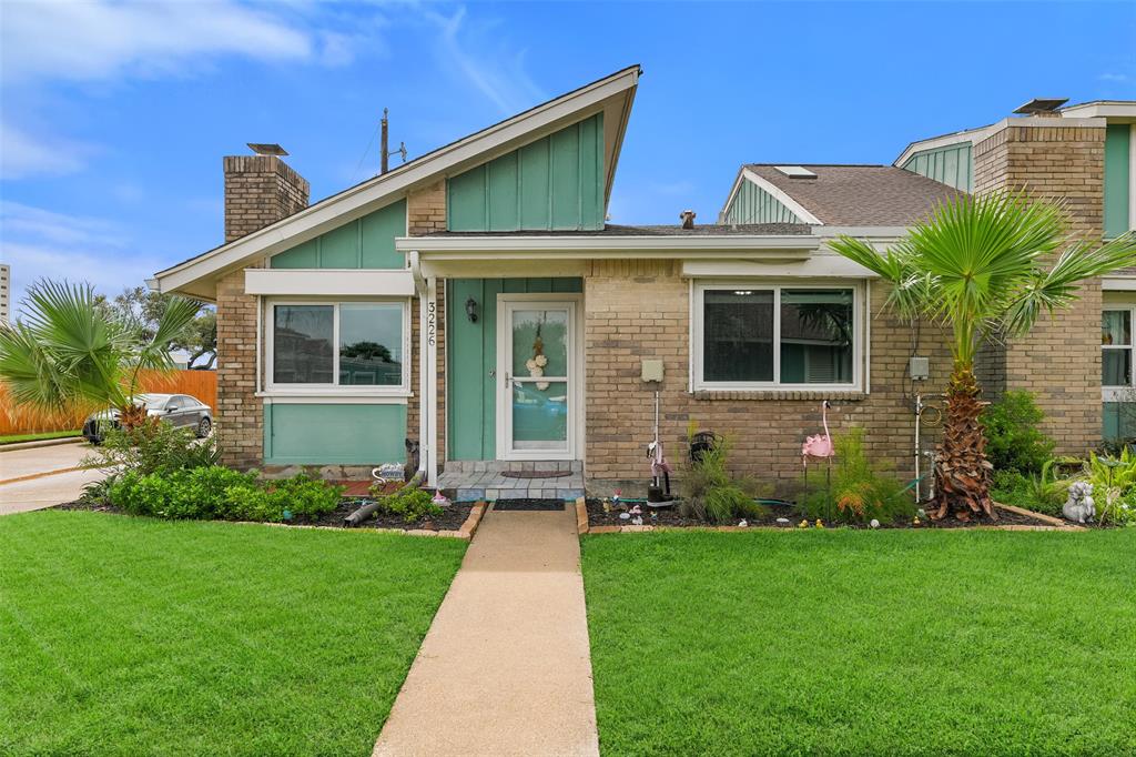 a front view of a house with a garden and plants