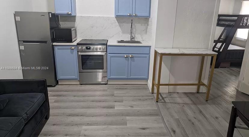 a kitchen with a stove and a refrigerator