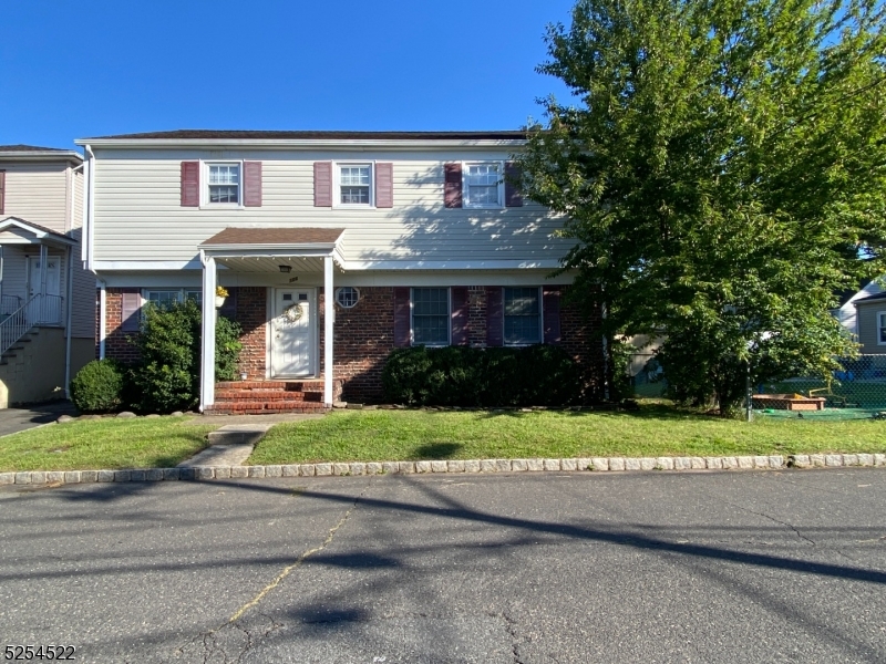 a front view of a house with a yard and porch