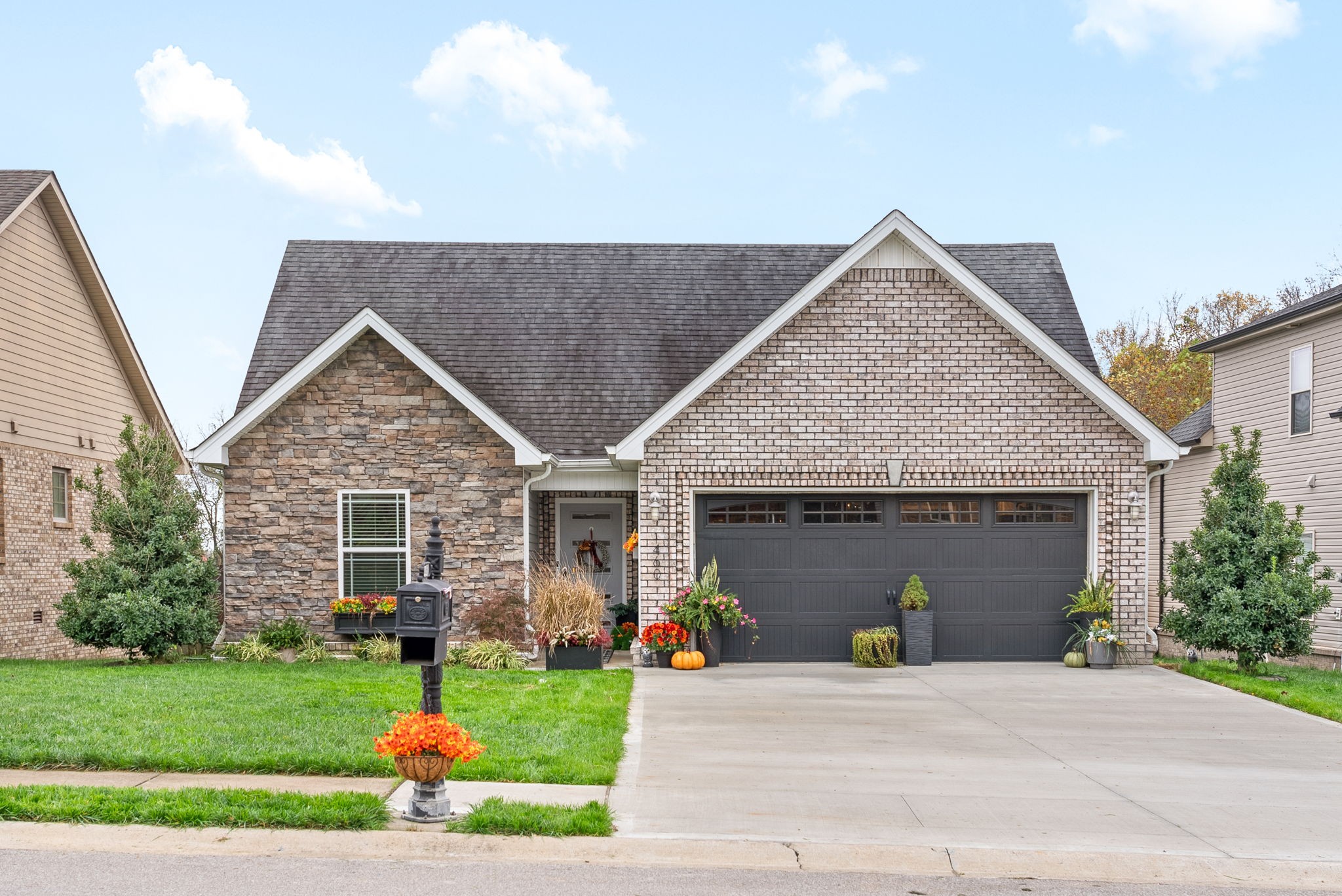 a front view of a house with a yard and garage