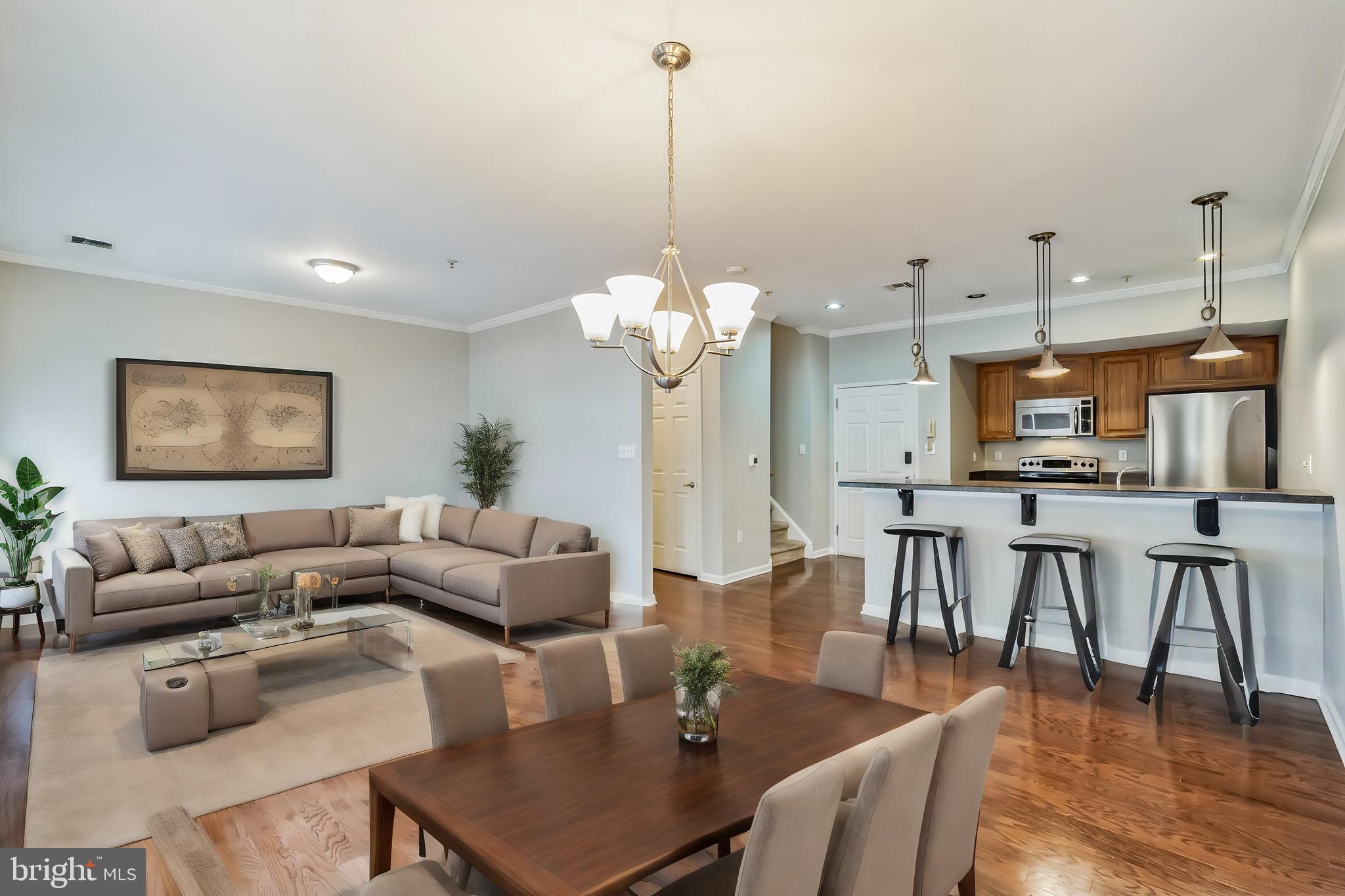 a living room with furniture a table and chairs