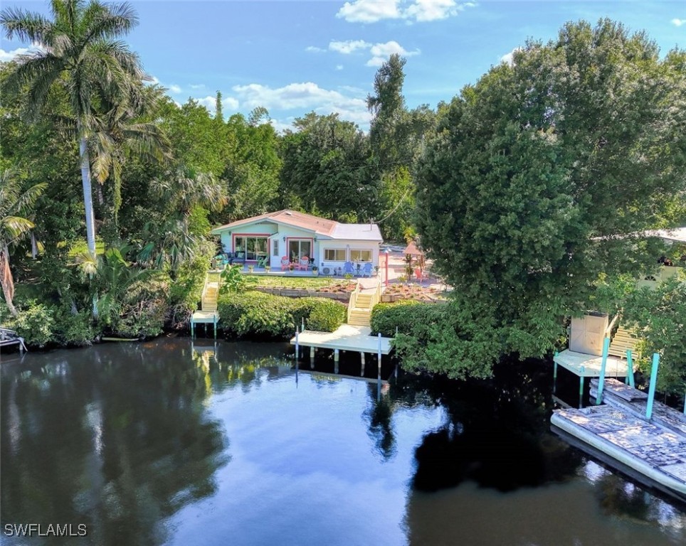 a view of a house with pool and lake view