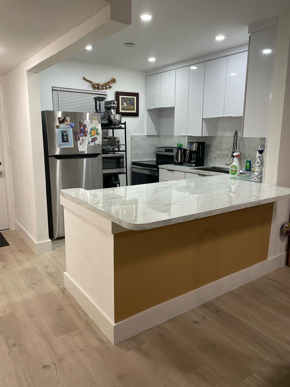 a kitchen with stainless steel appliances granite countertop a refrigerator and a stove