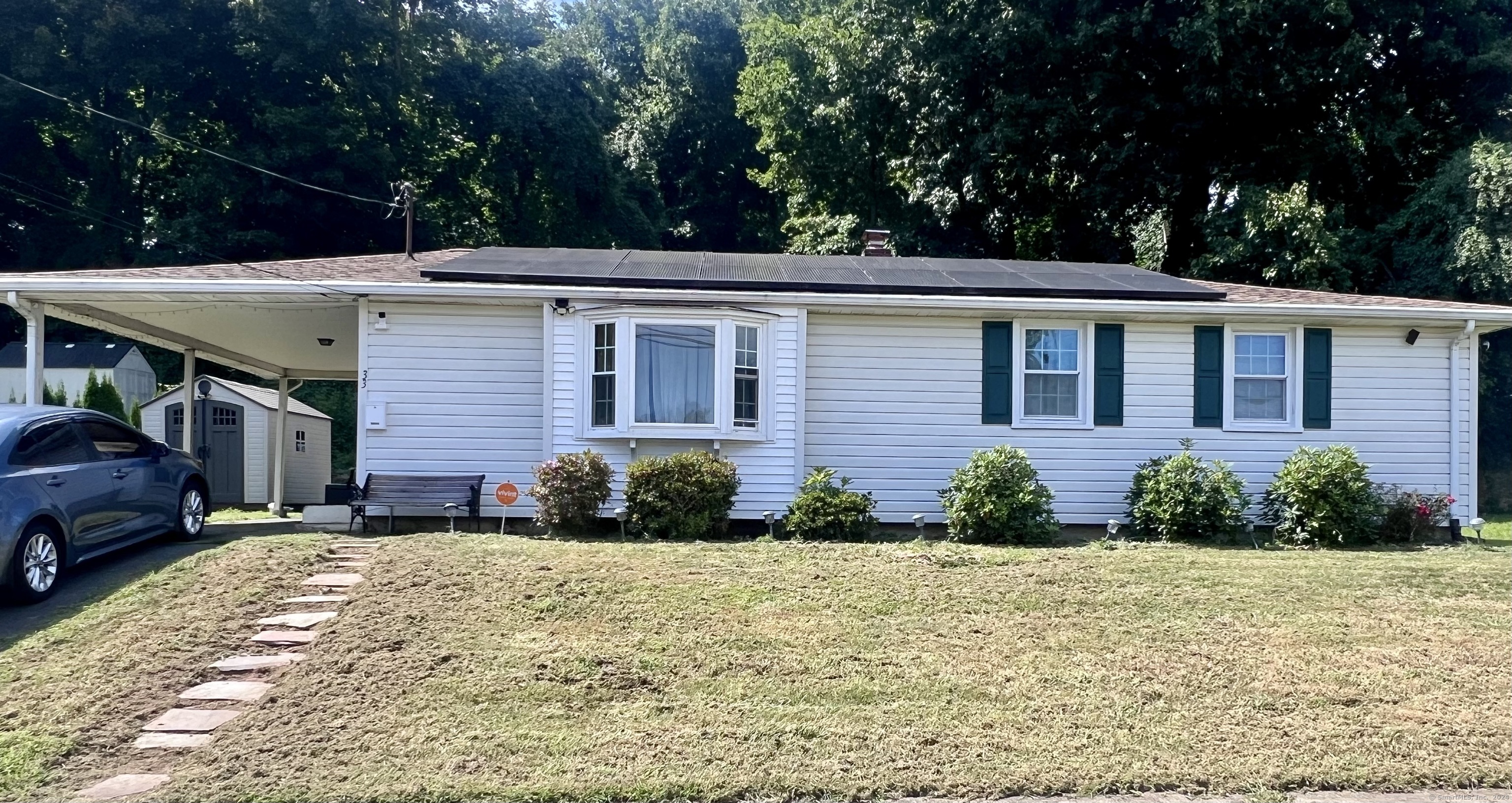 a front view of a house with garden