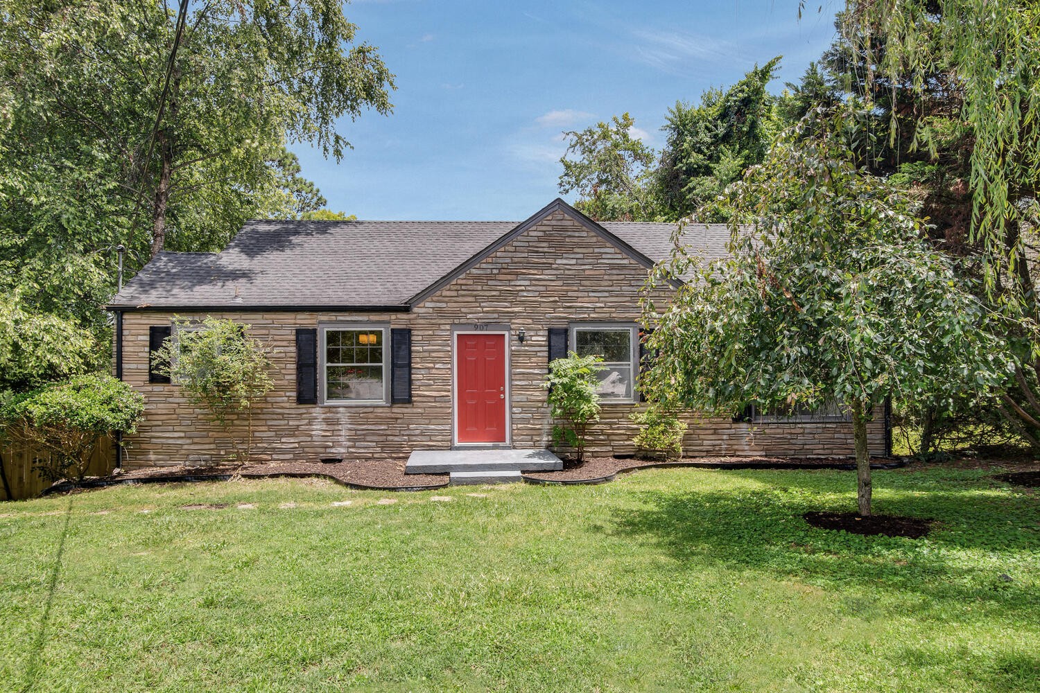 a front view of house with yard and green space