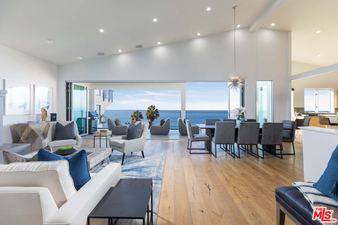 a living room with lots of furniture and a wooden floor