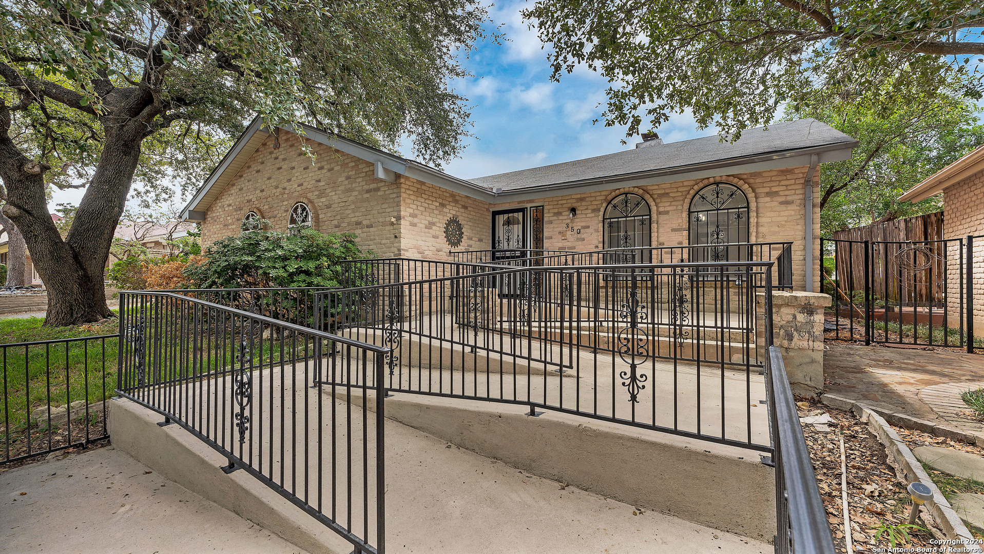 a front view of a house with a iron gate