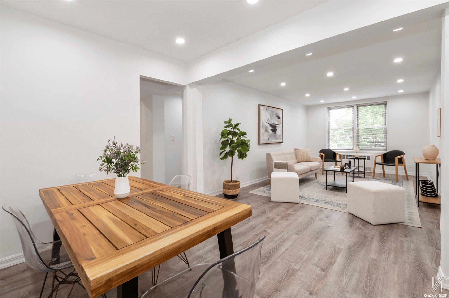 a living room with furniture potted plant and wooden floor