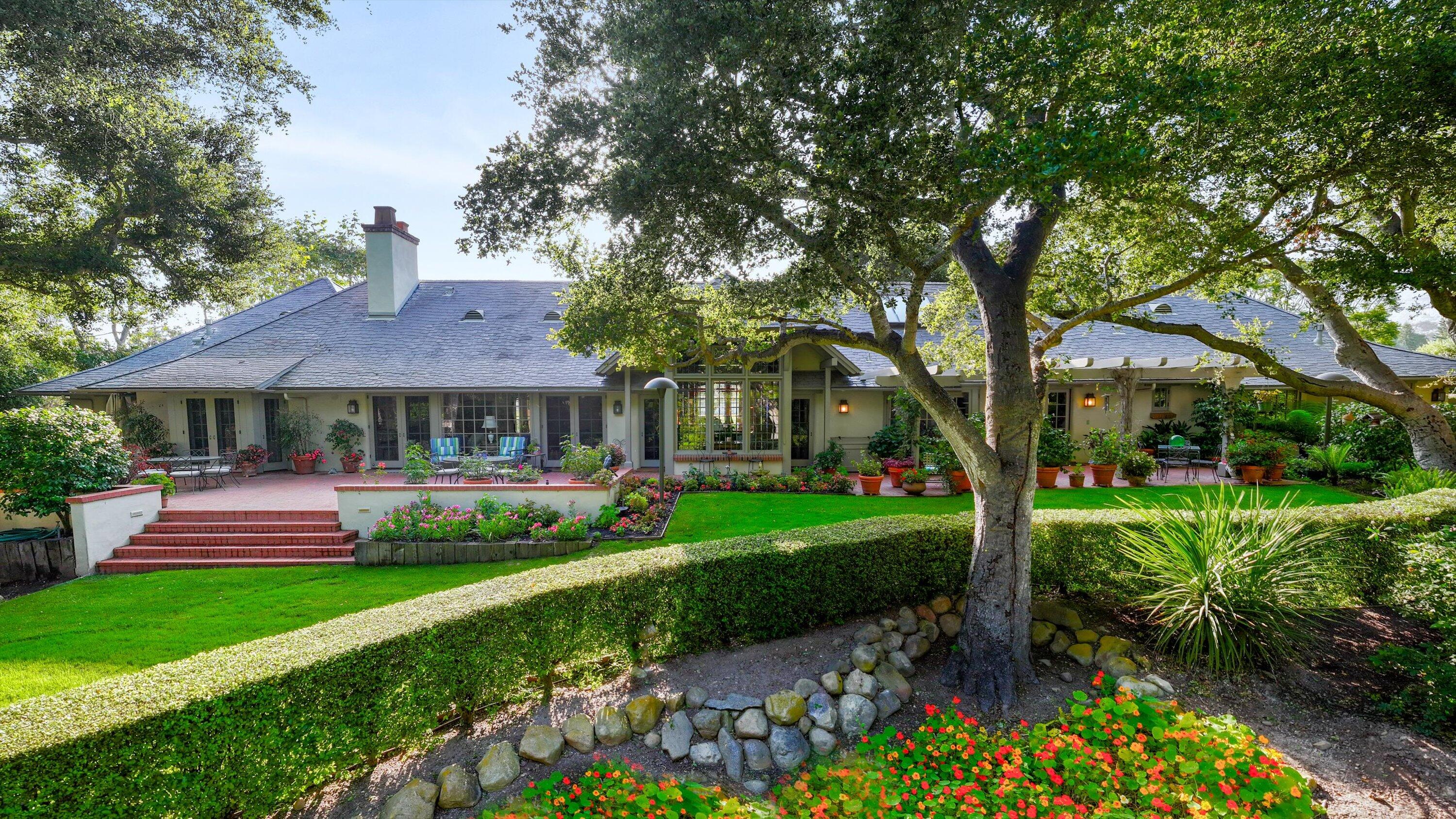 a front view of a house with a garden