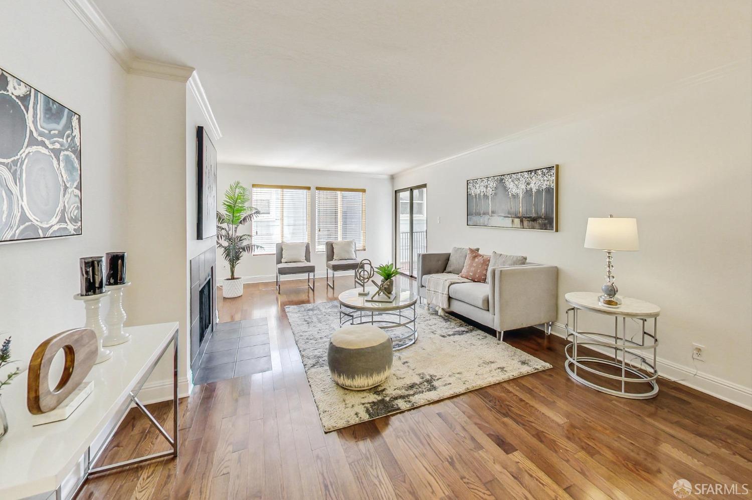 a living room with furniture a rug and a table