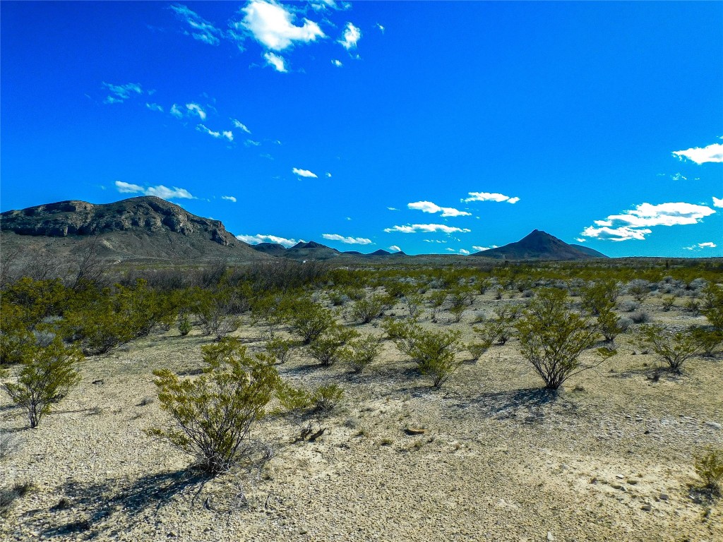 a view of a building with mountains in the background