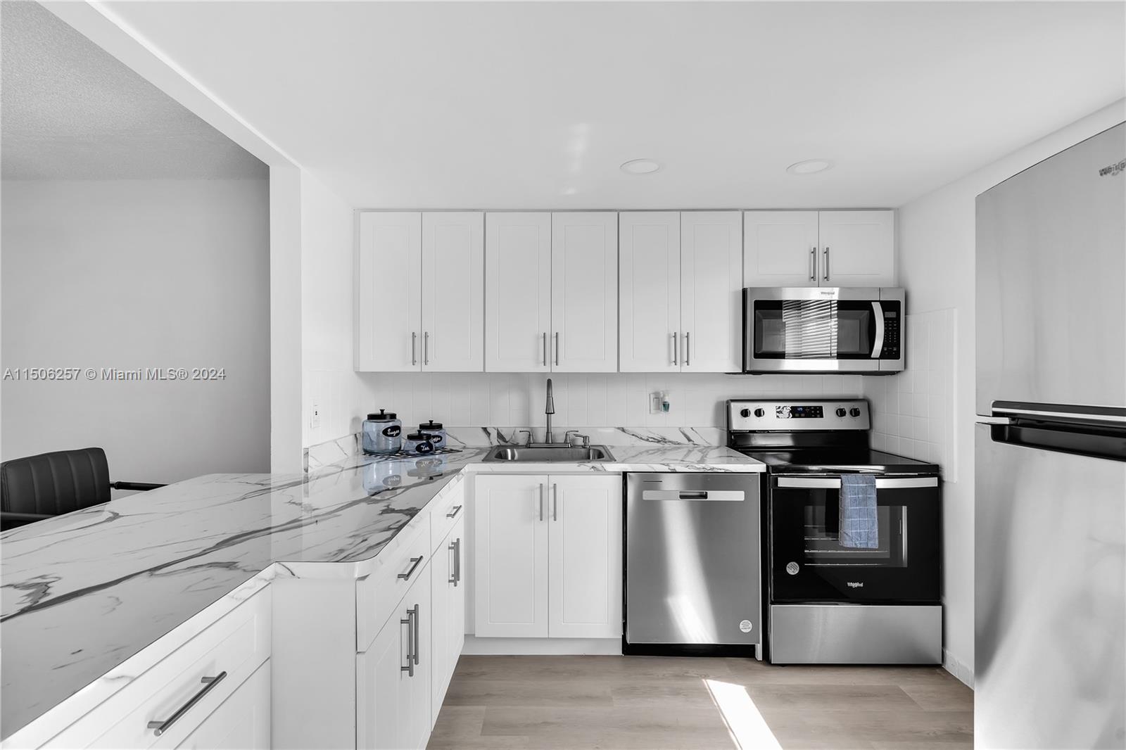 a kitchen with stainless steel appliances granite countertop a sink and a stove