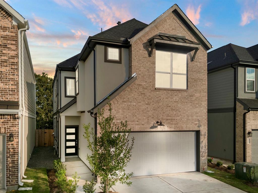 a front view of a house with garage