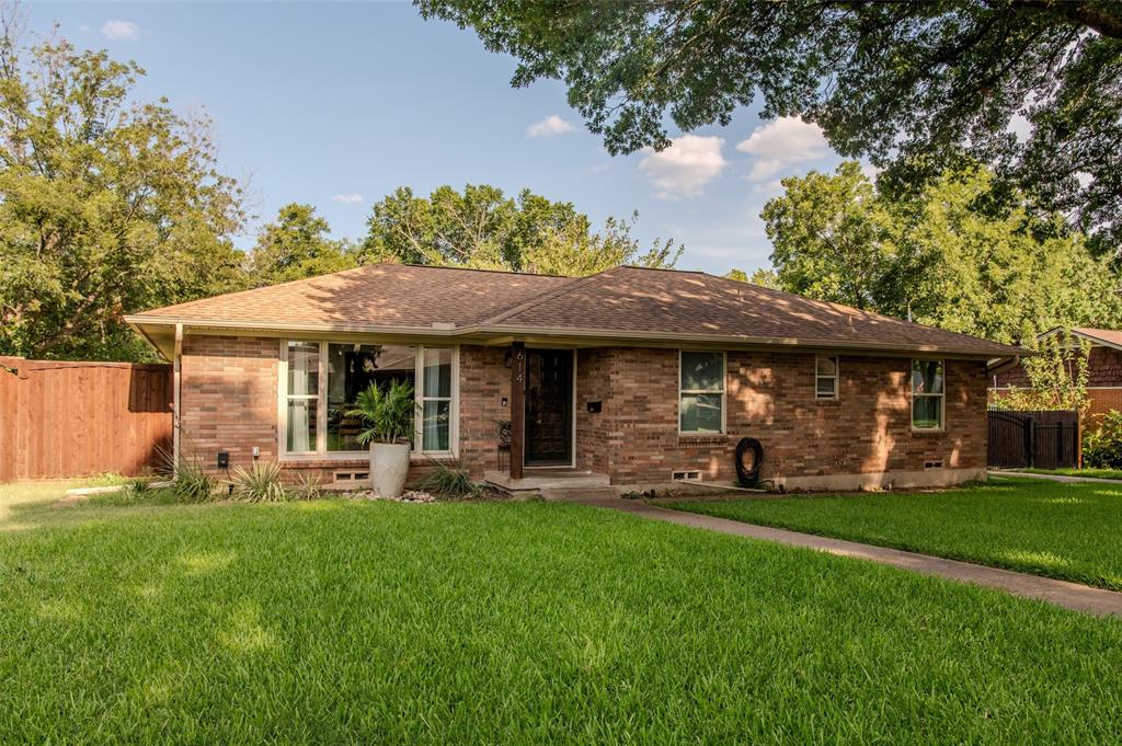 a view of a house with a yard and sitting area