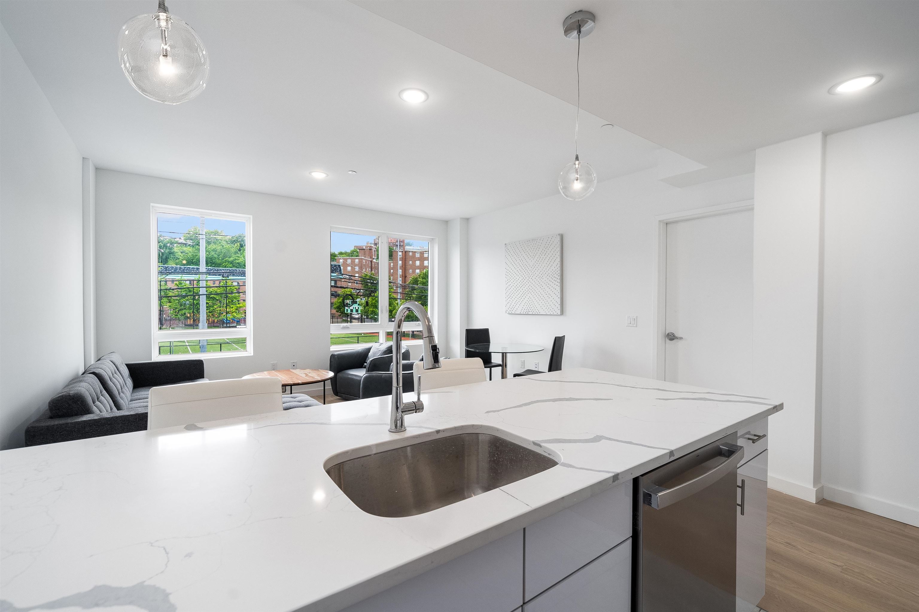 a kitchen with a sink a large window and cabinets