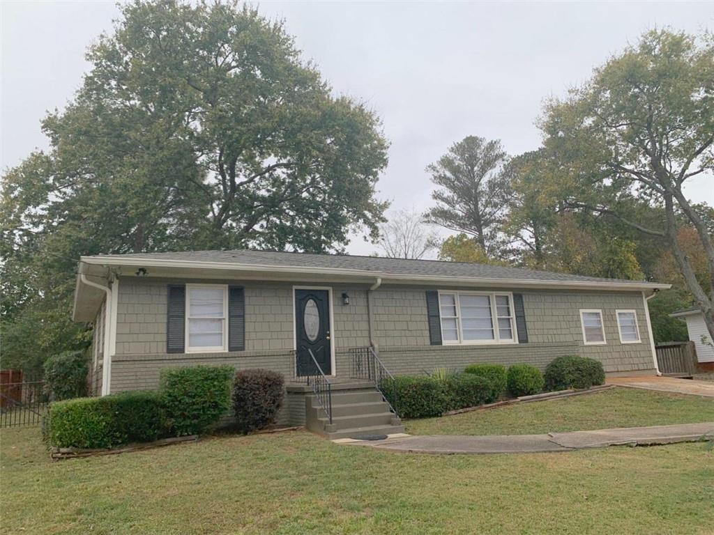 a front view of a house with a garden