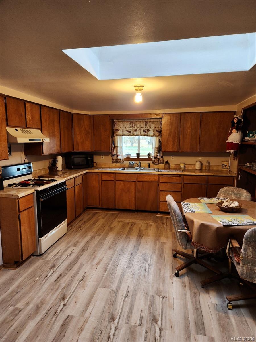 a kitchen with stainless steel appliances granite countertop a sink dishwasher stove and cabinets