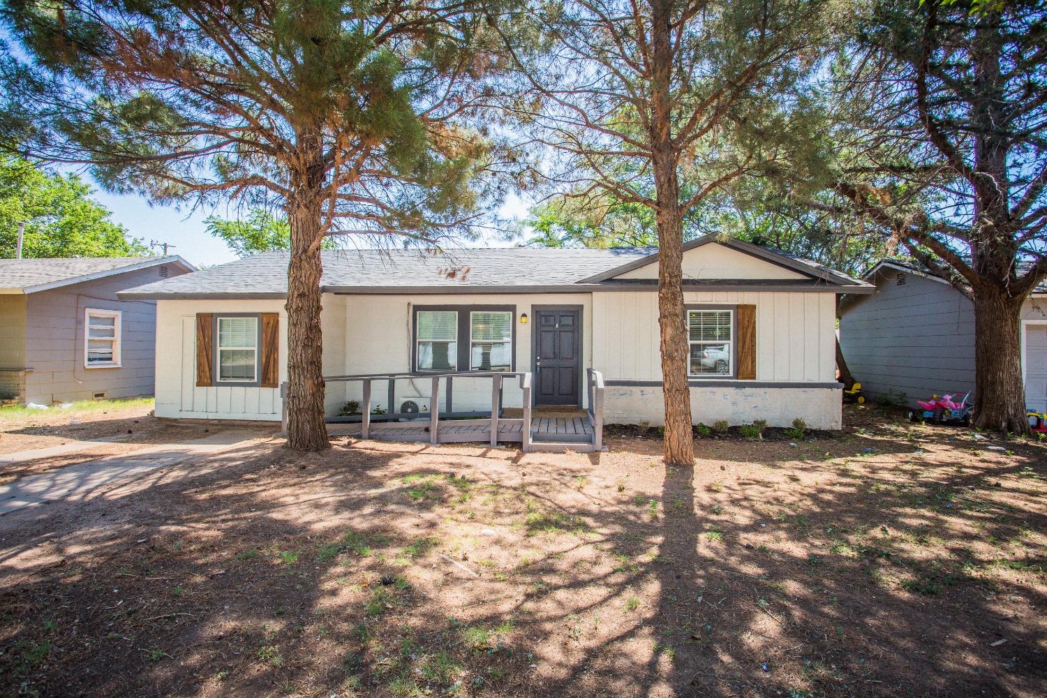 a house that has a tree in front of it