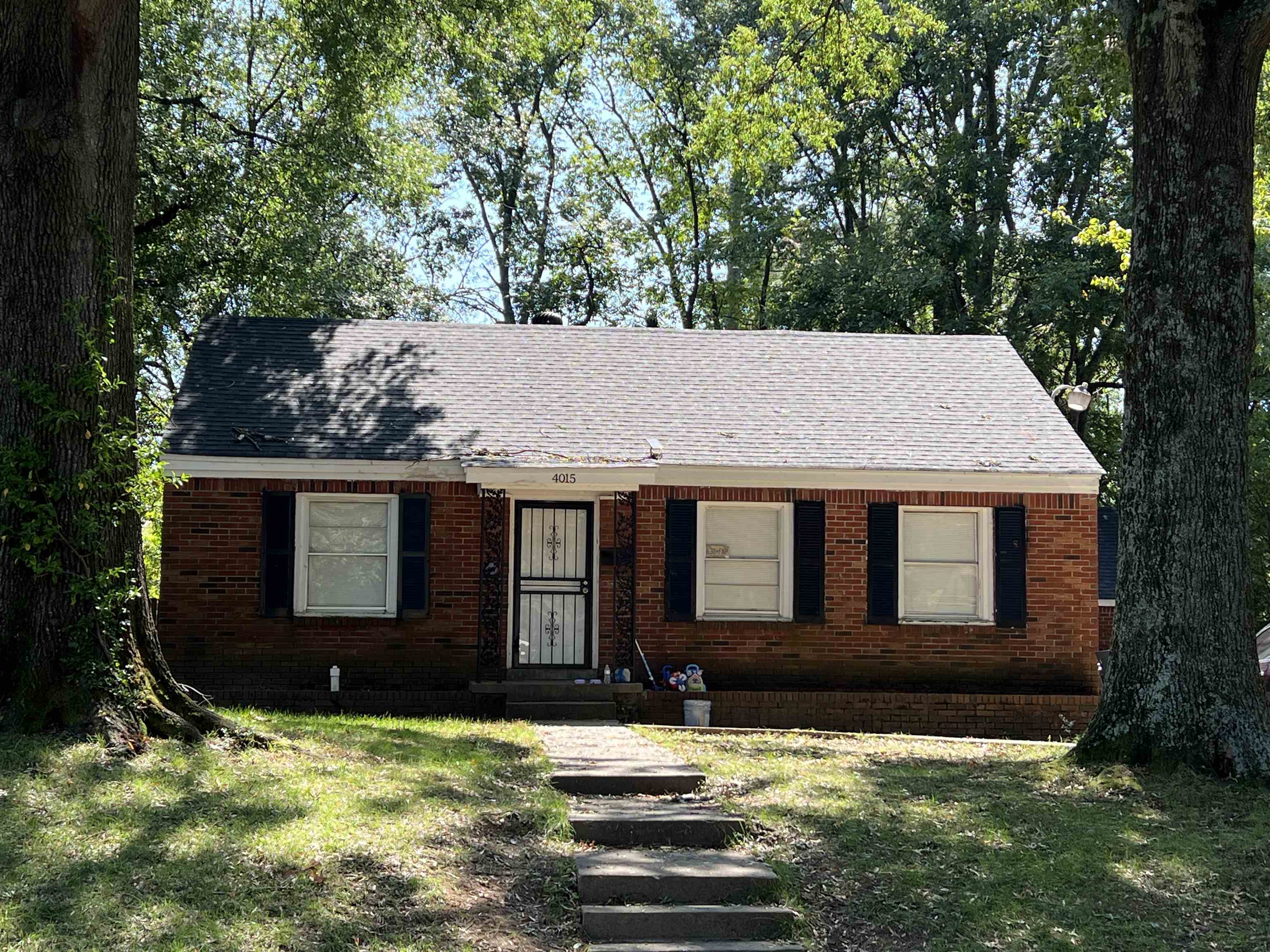 a view of a house with yard and sitting area