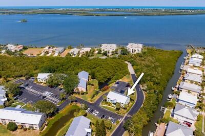 an aerial view of ocean with residential house with outdoor space