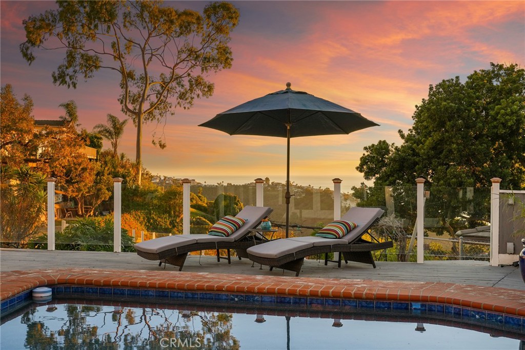 a view of a outdoor space with furniture and umbrella