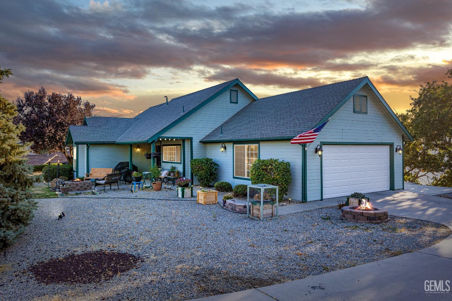 a view of a house with backyard and chairs