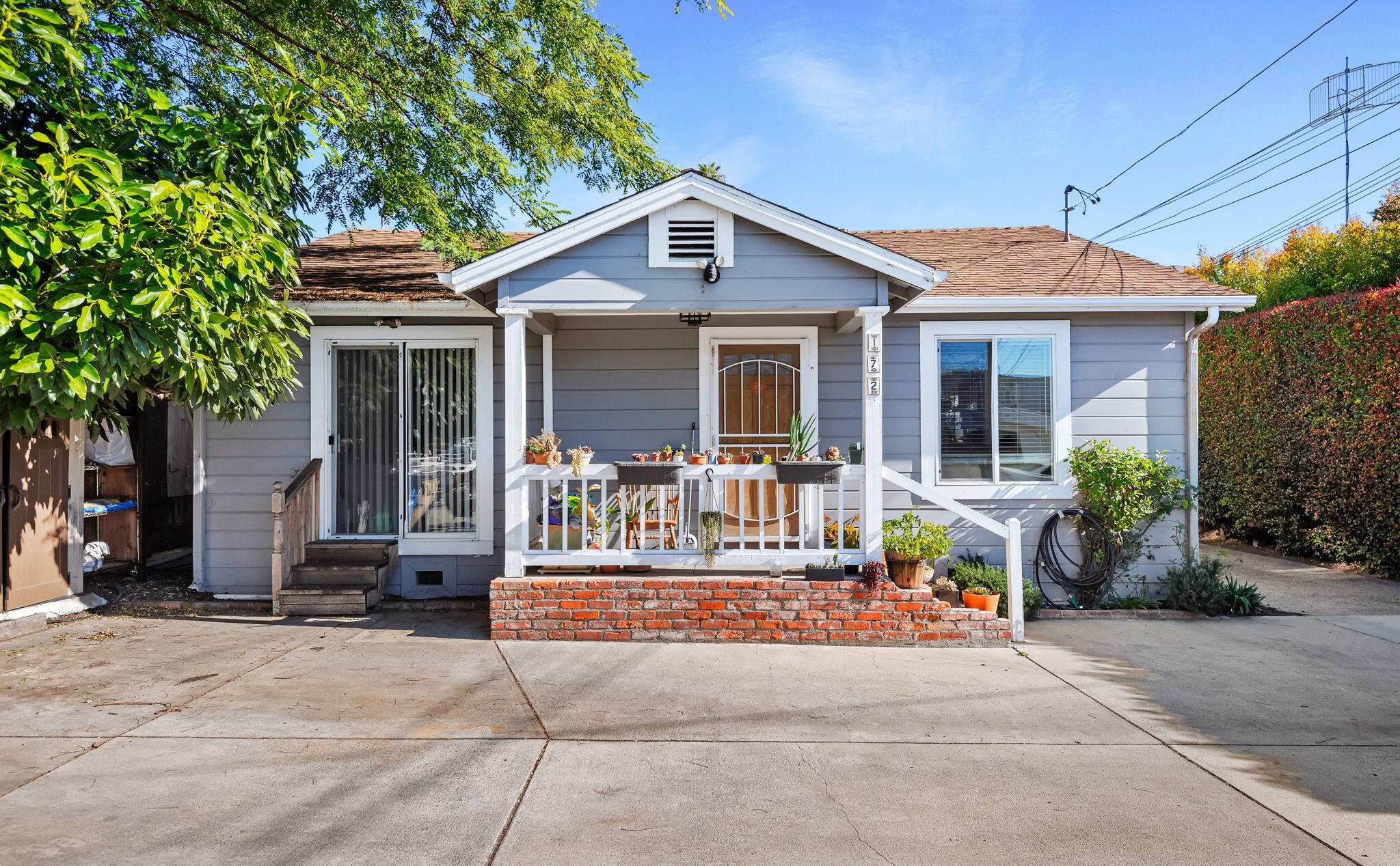 a front view of house with yard outdoor seating and barbeque oven