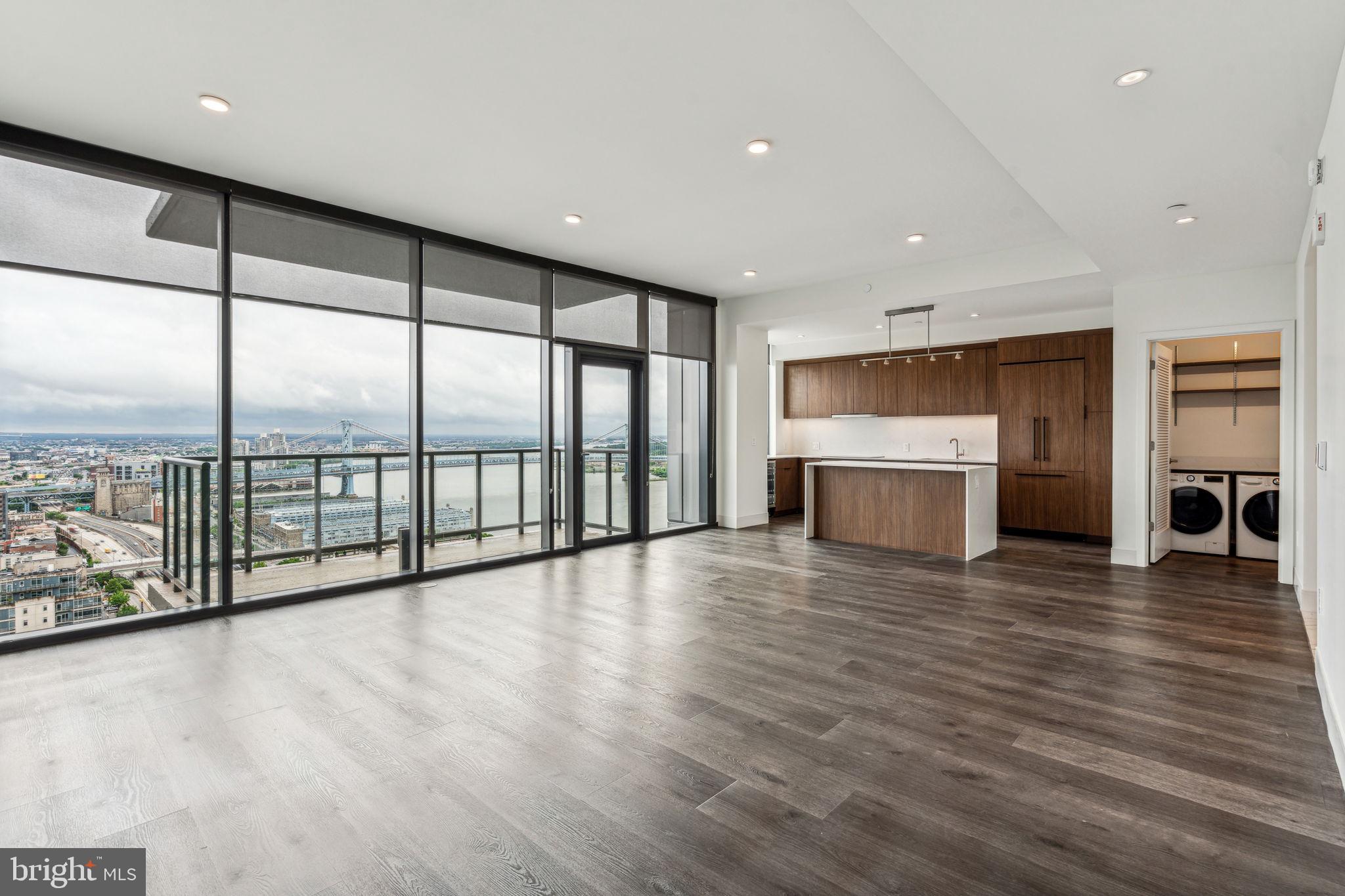 a view of empty room with wooden floor and fireplace