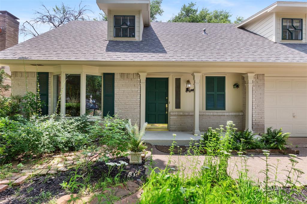 front view of a house with potted plants