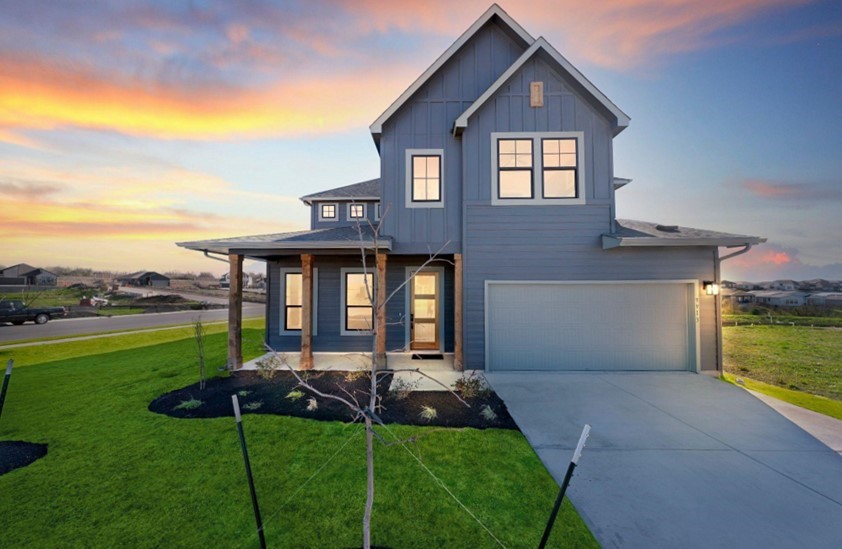 a front view of house with yard and outdoor seating