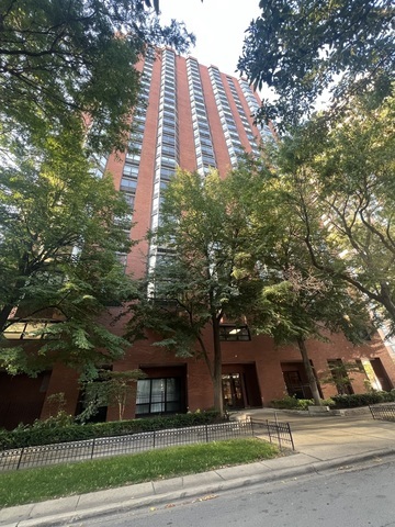 a view of a tall building next to a road