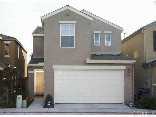 a front view of a house with garage