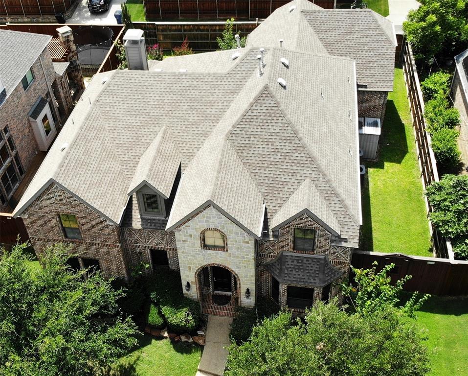 an aerial view of a house with a yard