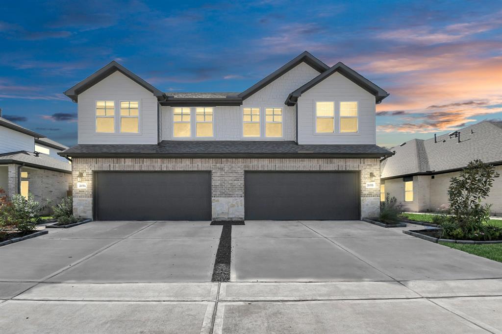 a front view of a house with yard and garage