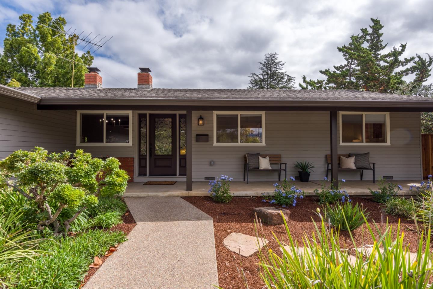 a front view of a house with garden