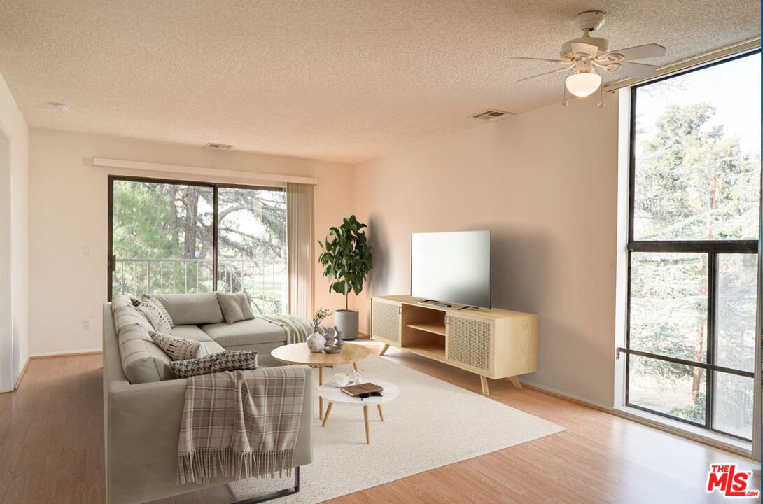 a living room with furniture and a large window