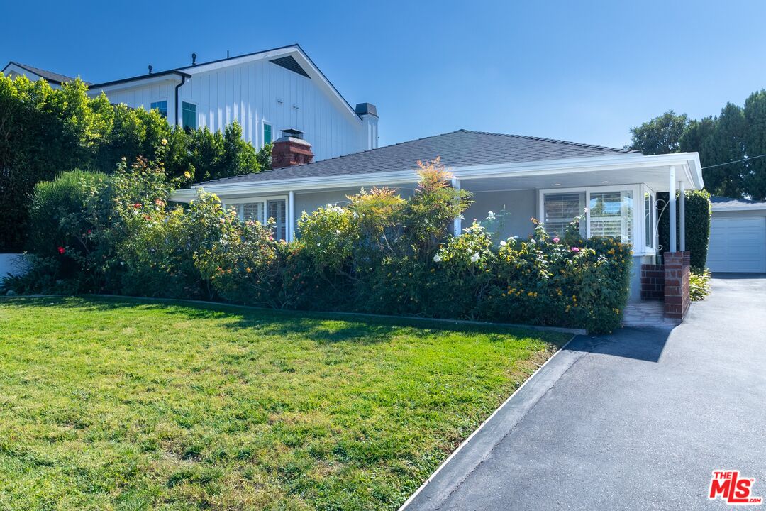 a view of a house with garden and yard