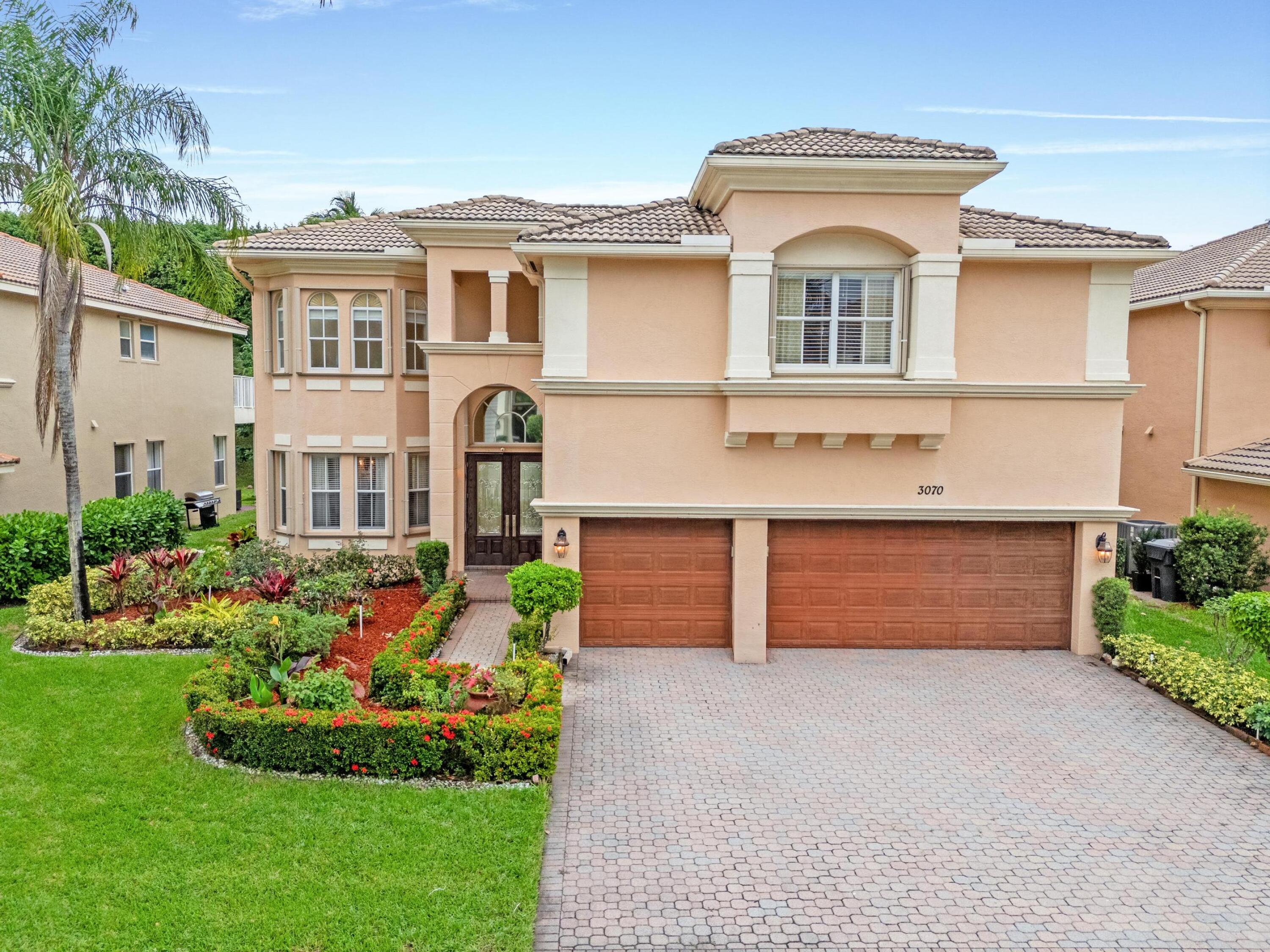 a front view of a house with a yard and garage