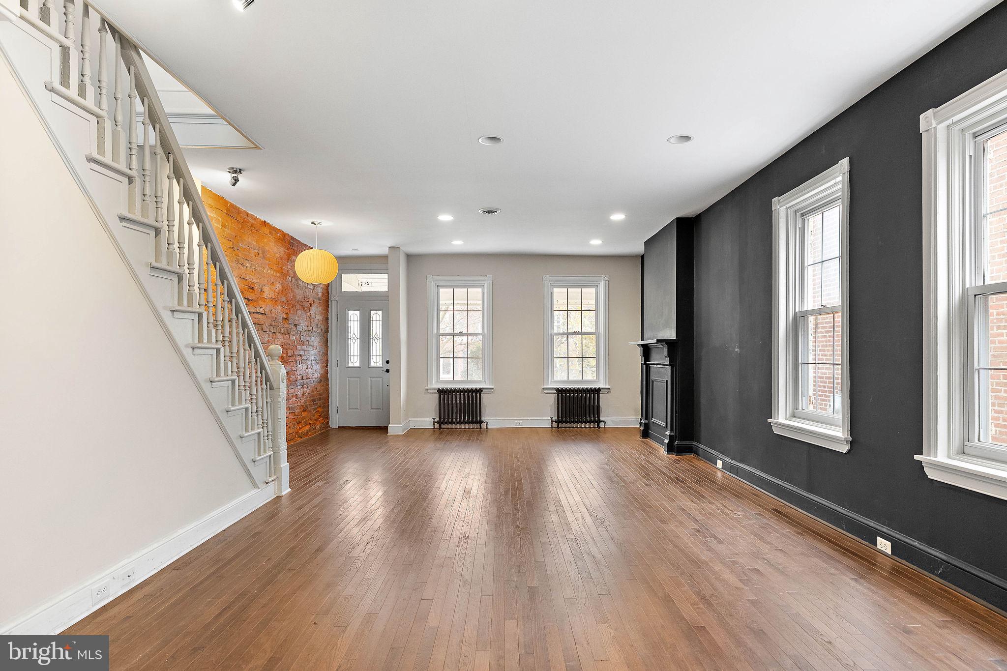 a view of livingroom with hardwood floor and windows