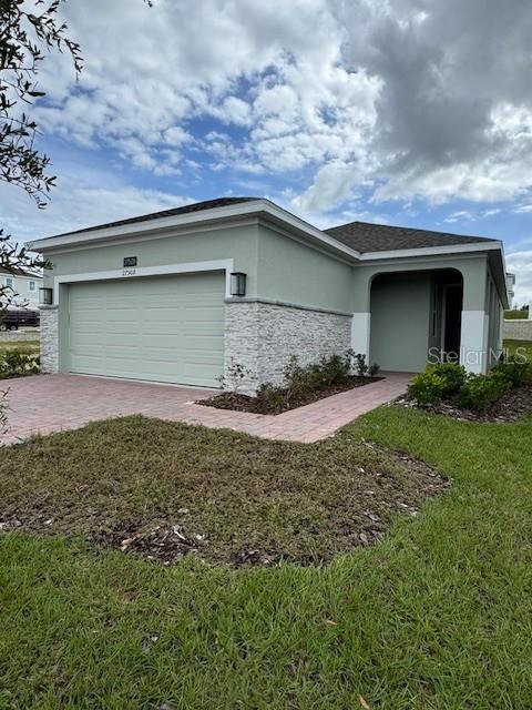 a front view of a house with a yard and garage