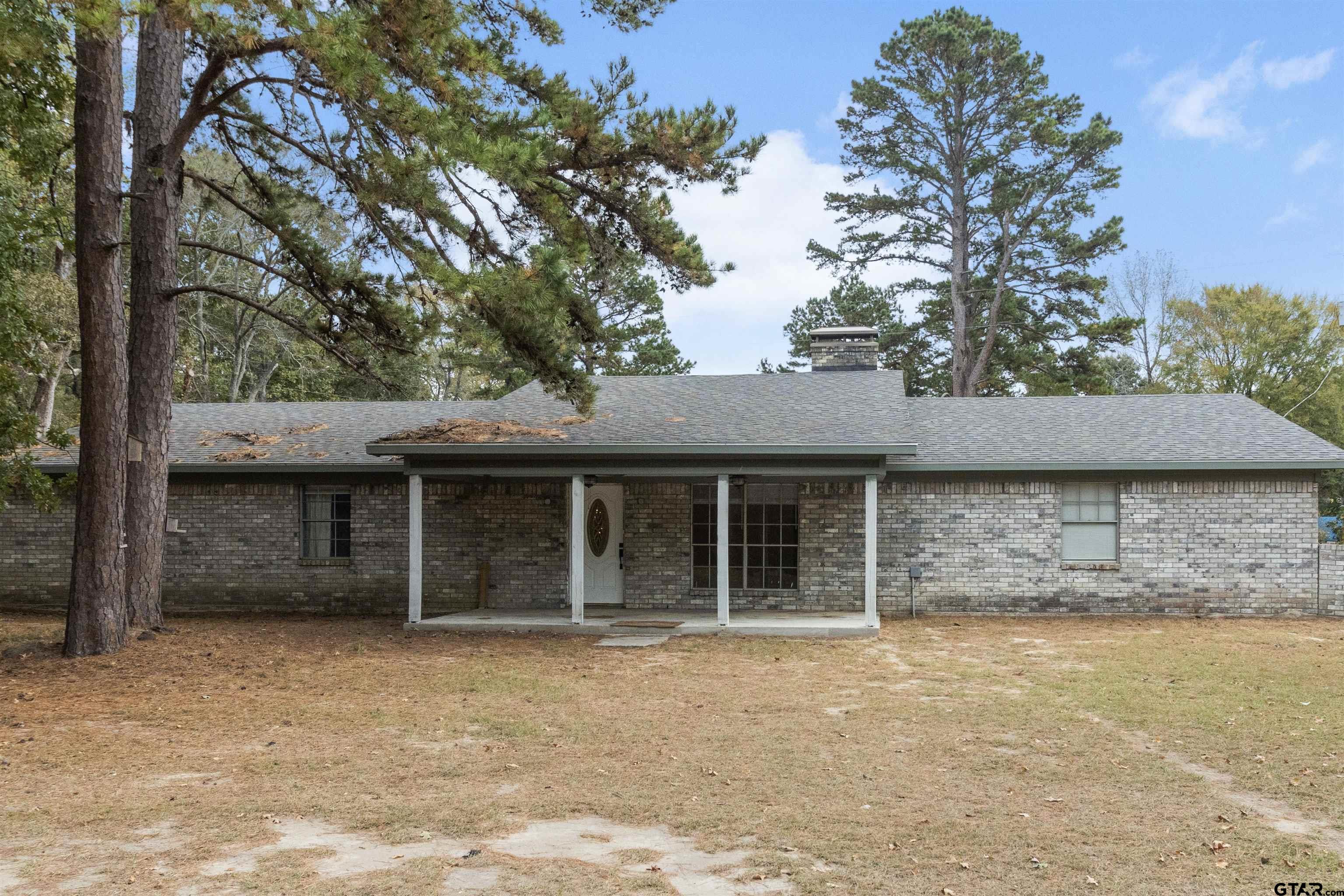 a house with trees in the background