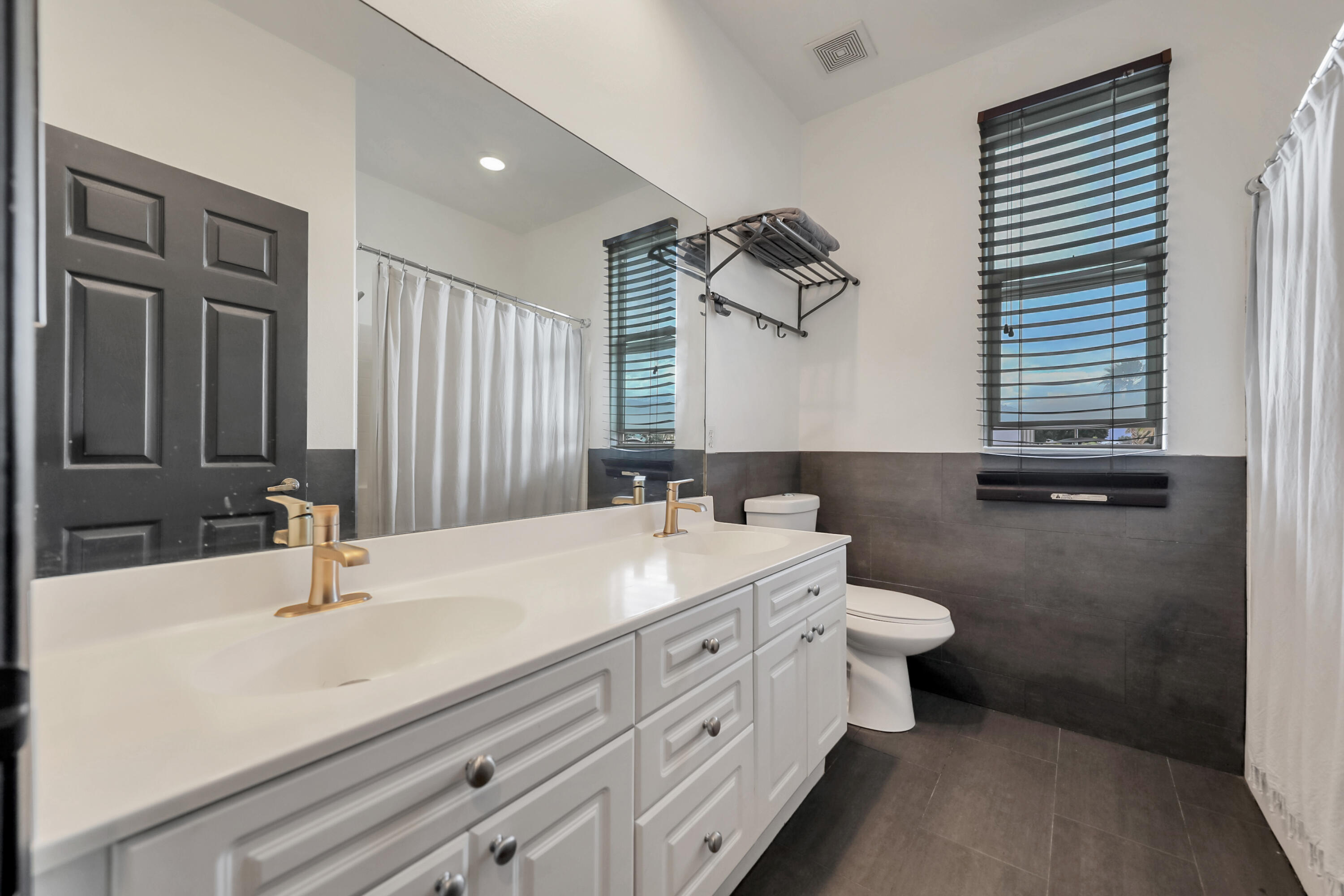 a bathroom with a double vanity sink and mirror