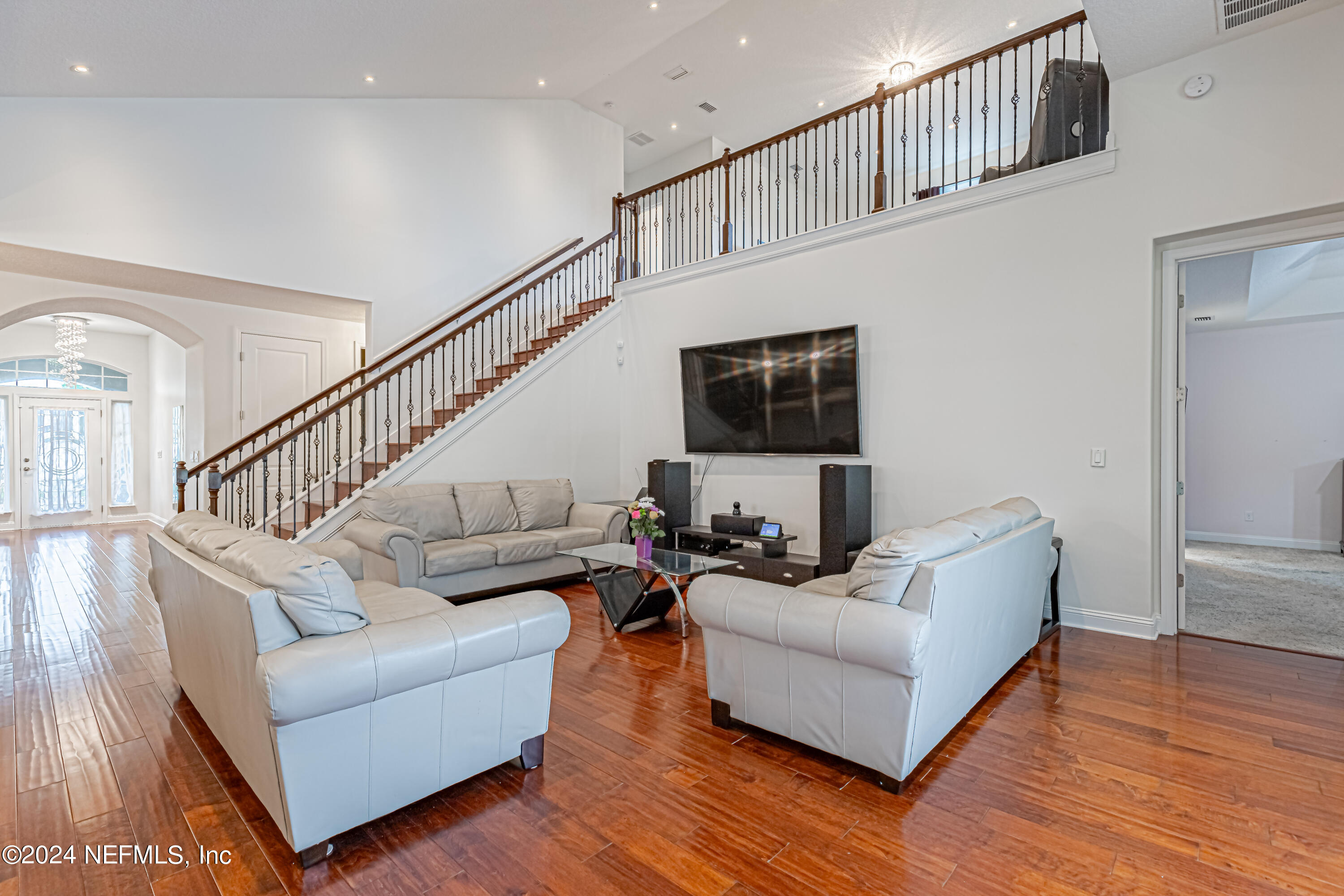 a living room with furniture and a flat screen tv