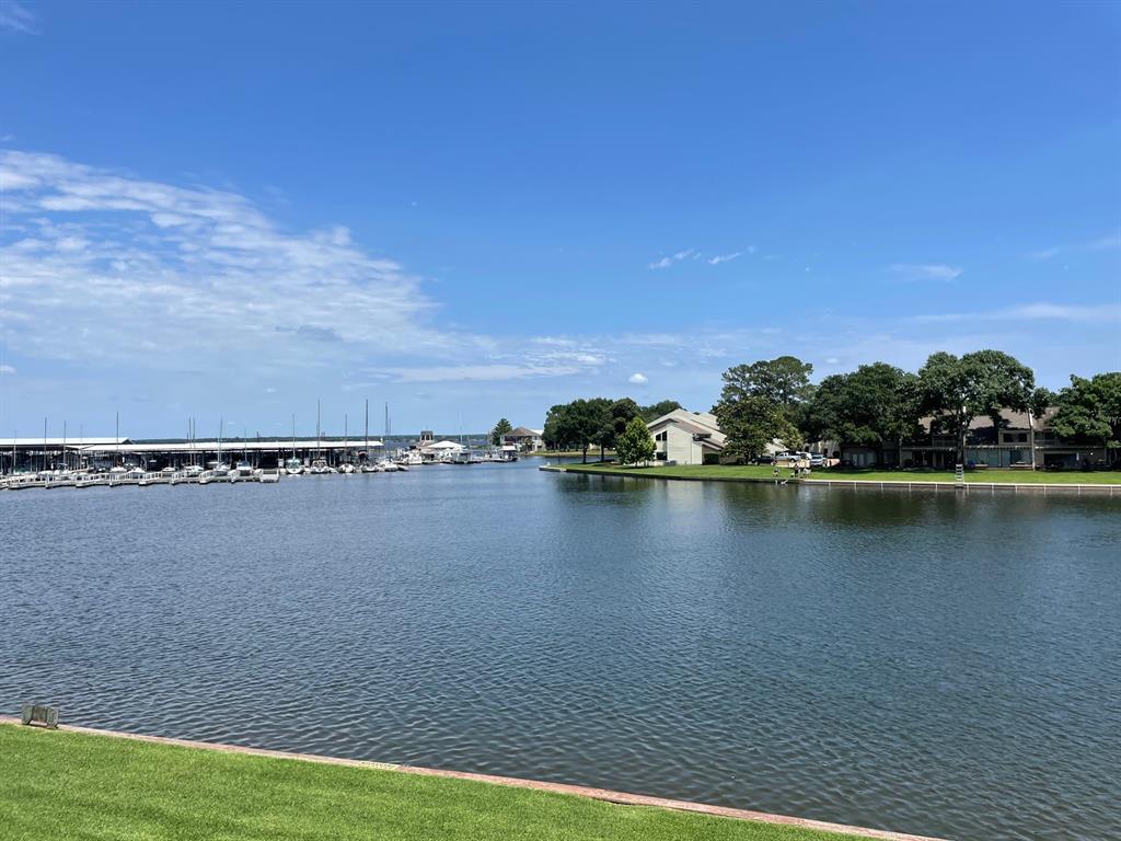 a view of a lake with houses in the back