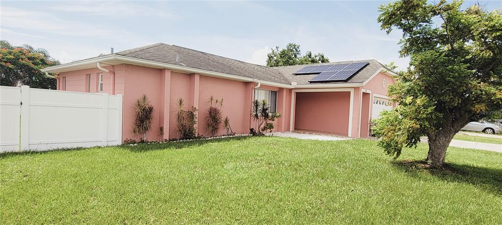 a front view of house with yard and trees