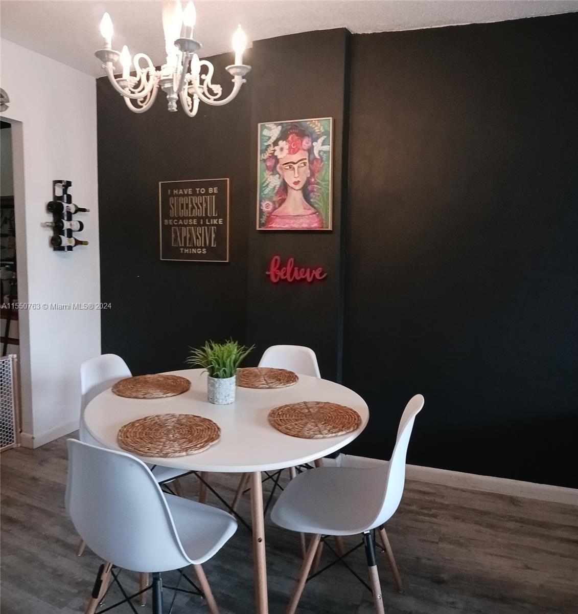 a view of a dining room with furniture wooden floor and a chandelier