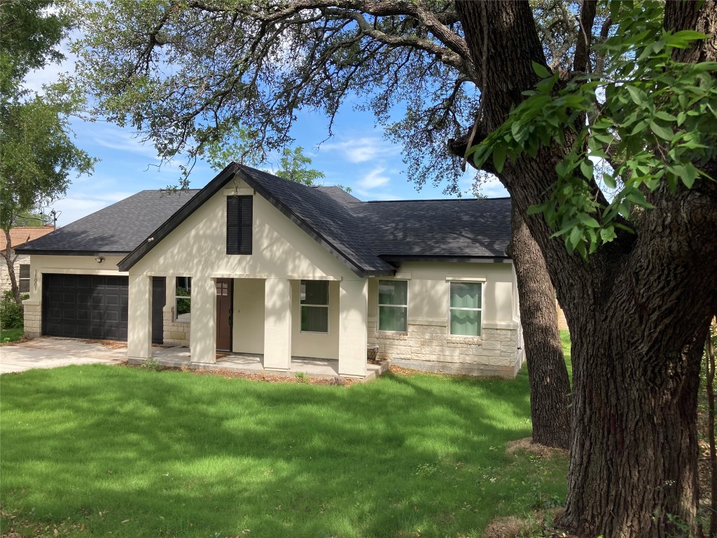 a front view of house with yard and green space