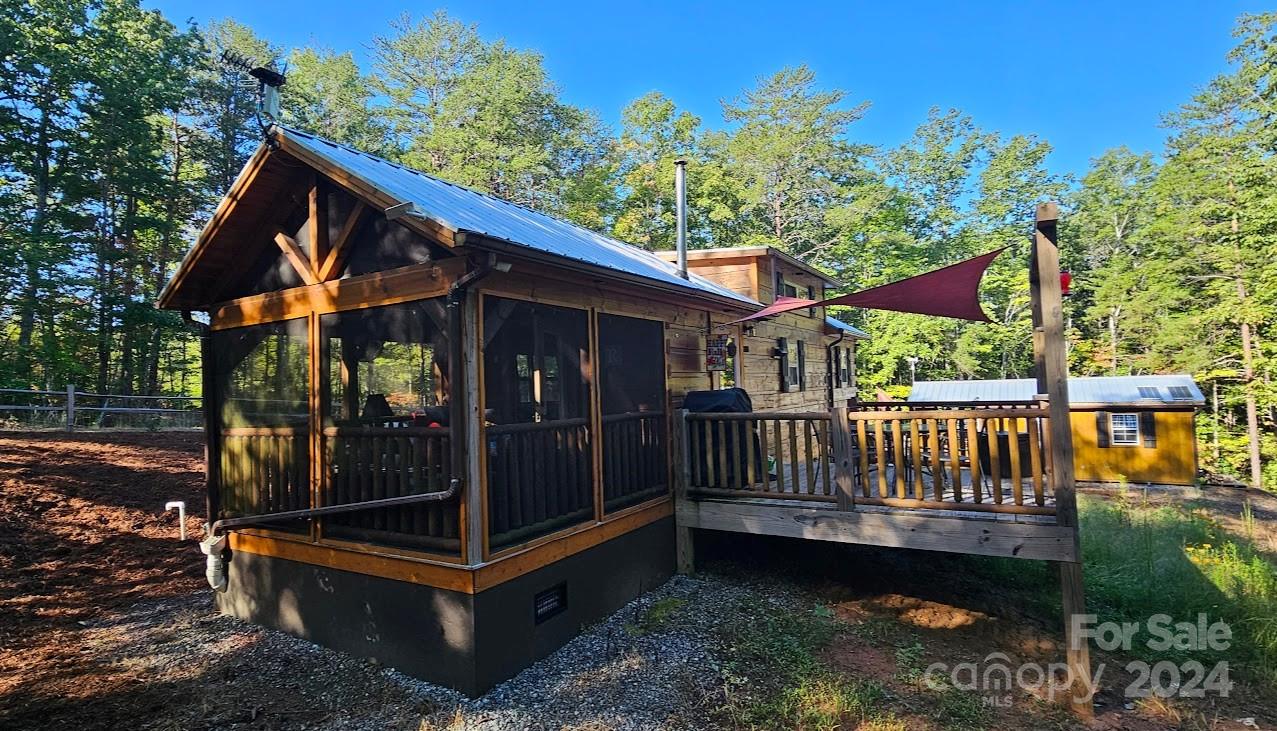 a view of backyard with a deck and wooden floor